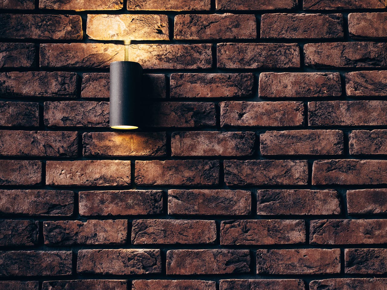 creative Contemporary brick wall design featuring a sleek accent light.